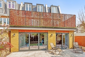 The interiors blend sustainable design with a rich palette of natural materials like brick, wood, and tiles, inspired by nature. The integration of eco-friendly construction methods and smart home technology ensures an energy-efficient, modern living environment.