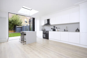 Open-concept living, dining, and kitchen area with a black and white color scheme, high-contrast furnishings, and modern design.