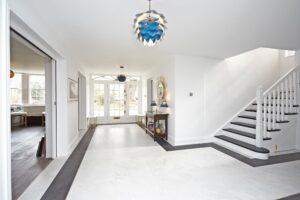 Stairs hall with black and white color scheme and a modern pocket door.